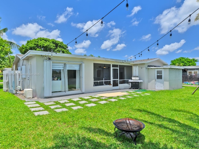 11610 NW 32nd Mnr, Sunrise, FL 33323 - back of property with stucco siding, a sunroom, a fire pit, and ceiling fan