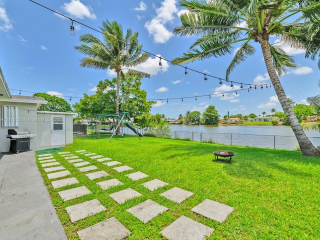 11610 NW 32nd Mnr, Sunrise, FL 33323 - view of yard featuring a playground, a water view, and an outdoor fire pit
