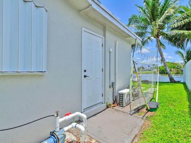 11610 NW 32nd Mnr, Sunrise, FL 33323 - entrance to property with stucco siding and a cooling unit