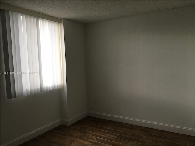 850 N Miami Ave Unit W-2003, Miami, FL 33136 - empty room featuring dark wood-style floors, baseboards, and a textured ceiling