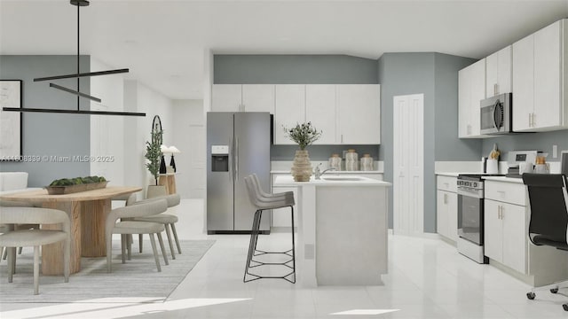 17372 SW 285th St, Miami, FL 33030 - kitchen with stainless steel appliances, white cabinetry, light countertops, and a center island with sink