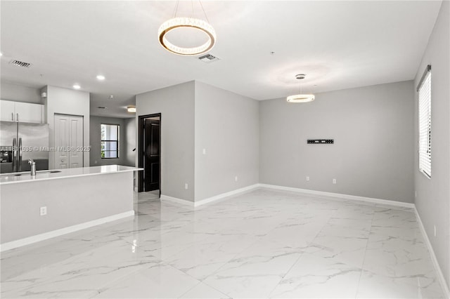 221 SW 159th Way, Pembroke Pines, FL 33027 - unfurnished living room with baseboards, light marble finish flooring, a sink, and recessed lighting