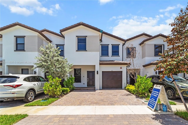 221 SW 159th Way, Pembroke Pines, FL 33027 - townhome / multi-family property with stucco siding, a garage, and decorative driveway