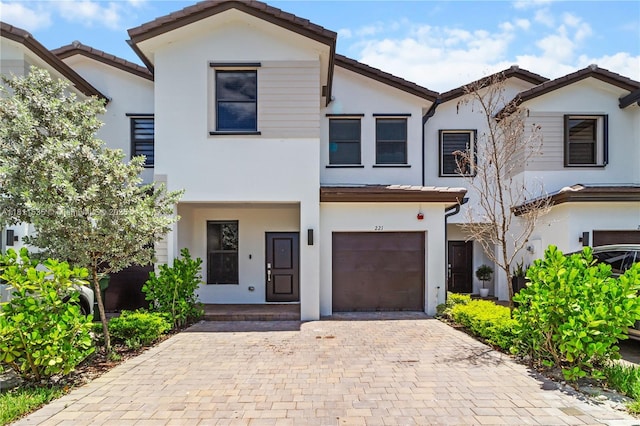 221 SW 159th Way, Pembroke Pines, FL 33027 - townhome / multi-family property featuring an attached garage, stucco siding, decorative driveway, and a tiled roof