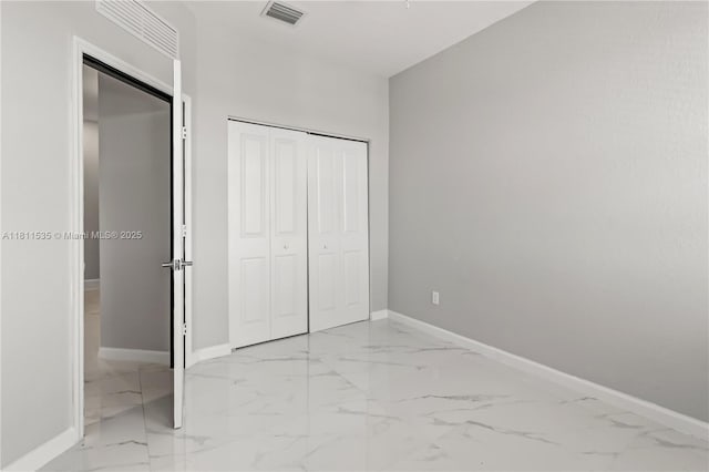 221 SW 159th Way, Pembroke Pines, FL 33027 - unfurnished bedroom featuring light marble finish floors, baseboards, and a closet