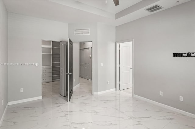 221 SW 159th Way, Pembroke Pines, FL 33027 - unfurnished bedroom featuring baseboards, light marble finish flooring, a spacious closet, a towering ceiling, and a closet