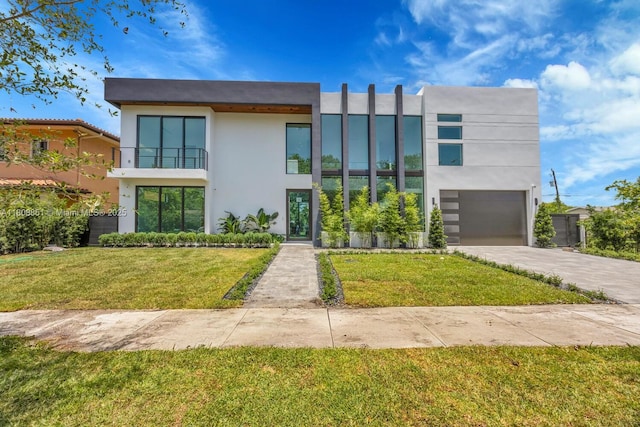 4231 SW 11th St, Miami, FL 33134 - contemporary home featuring stucco siding, driveway, a front lawn, a balcony, and an attached garage