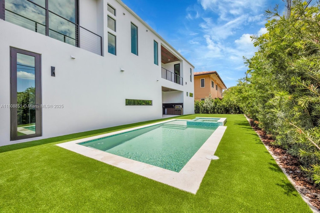 4231 SW 11th St, Miami, FL 33134 - view of swimming pool featuring a yard and a pool with connected hot tub