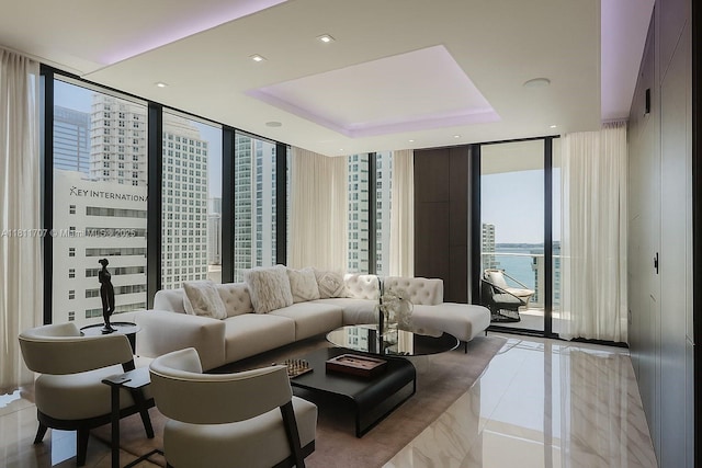 1010 Brickell Ave Unit 1501, Miami, FL 33131 - living room with floor to ceiling windows, light tile patterned floors, a tray ceiling, and recessed lighting