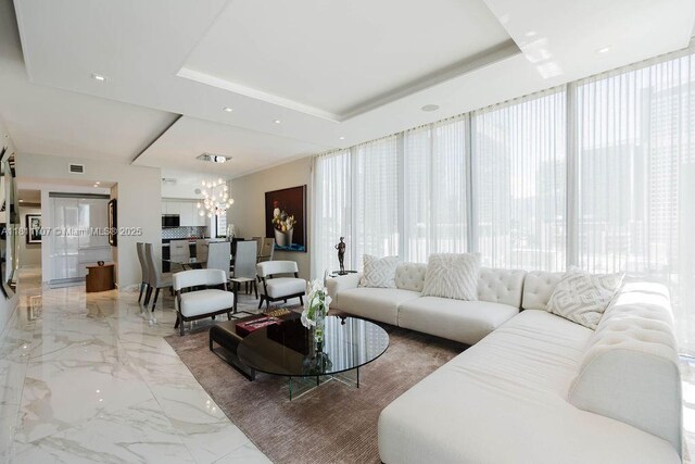 1010 Brickell Ave Unit 1501, Miami, FL 33131 - living area with light marble finish floors, a chandelier, and a raised ceiling