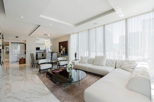 1010 Brickell Ave Unit 1501, Miami, FL 33131 - living room featuring light marble finish flooring, a chandelier, and a raised ceiling