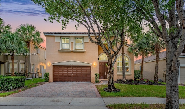 5064 SW 164th Ave, Miramar, FL 33027 - mediterranean / spanish home with an attached garage, decorative driveway, stucco siding, and a yard