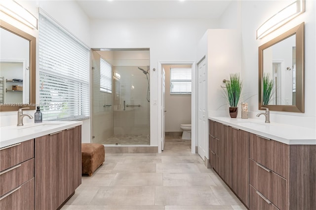 5064 SW 164th Ave, Miramar, FL 33027 - bathroom with a stall shower, toilet, two vanities, and baseboards