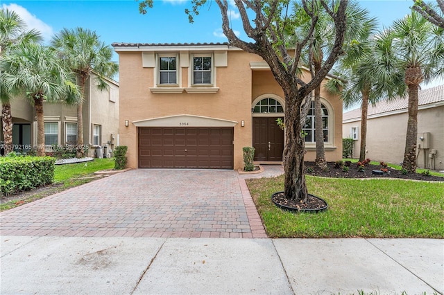 5064 SW 164th Ave, Miramar, FL 33027 - mediterranean / spanish-style home featuring a garage, driveway, stucco siding, and a front yard