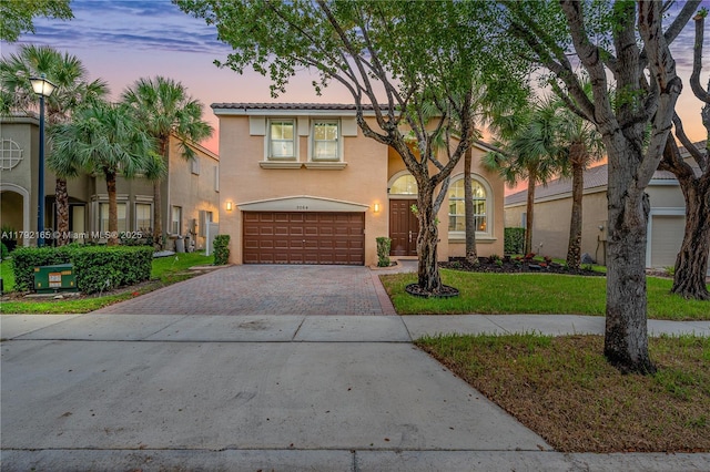 5064 SW 164th Ave, Miramar, FL 33027 - view of front of house featuring decorative driveway, an attached garage, stucco siding, a lawn, and a tile roof