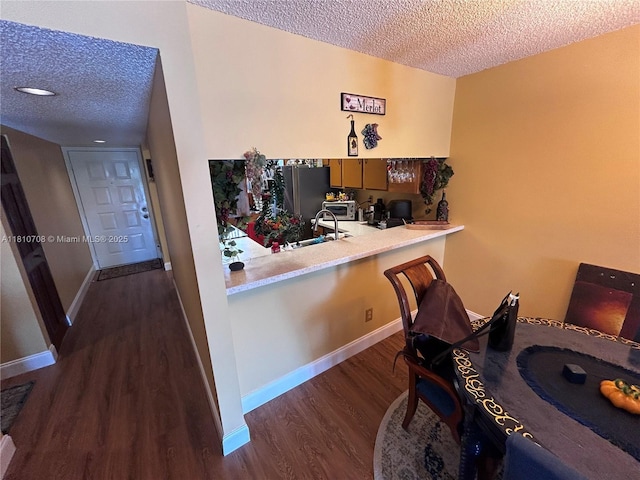 9577 W Mcnab Rd Unit 110, Tamarac, FL 33321 - dining area with a textured ceiling, dark wood-style floors, and baseboards