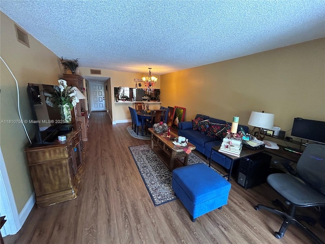 9577 W Mcnab Rd Unit 110, Tamarac, FL 33321 - living room with a chandelier, wood finished floors, a textured ceiling, baseboards, and an office area