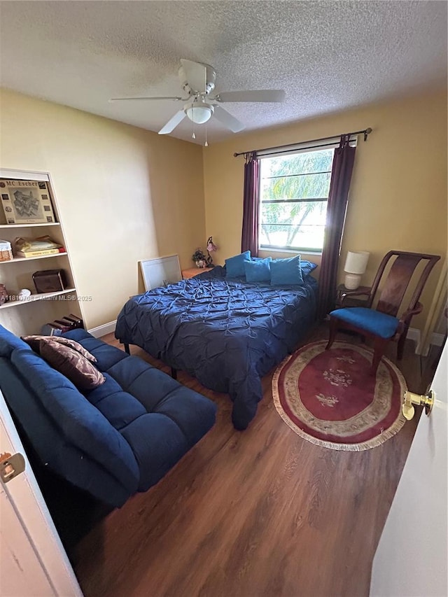 9577 W Mcnab Rd Unit 110, Tamarac, FL 33321 - bedroom featuring a textured ceiling, wood finished floors, and ceiling fan