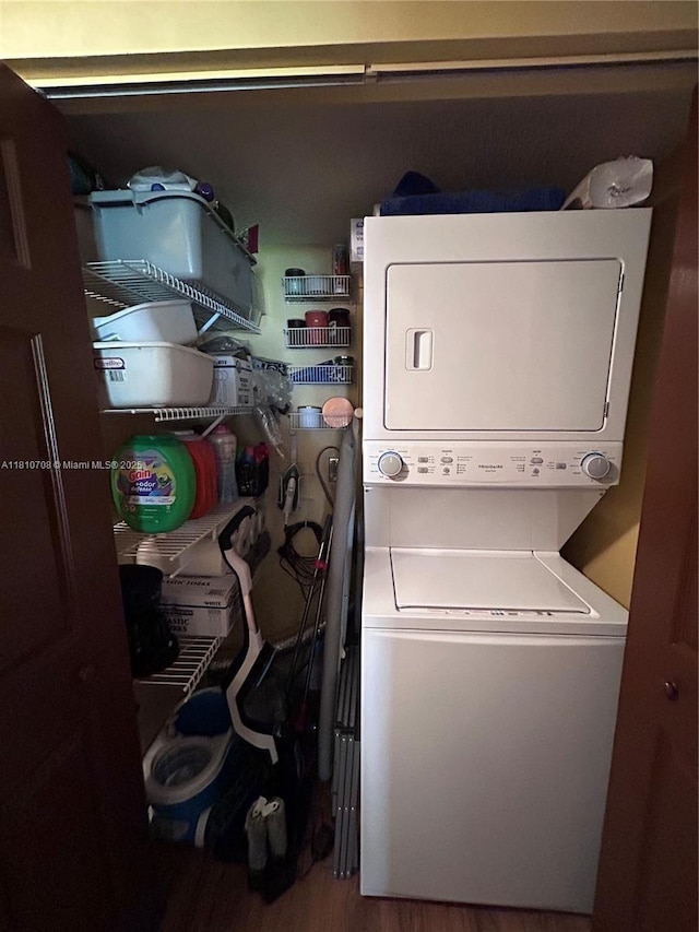 9577 W Mcnab Rd Unit 110, Tamarac, FL 33321 - laundry area with stacked washer / drying machine and wood finished floors
