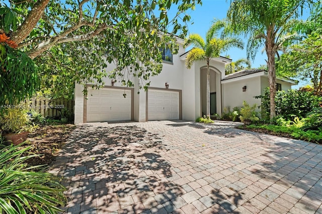 8205 SW 171st Ter, Palmetto Bay, FL 33157 - view of front of home with decorative driveway, stucco siding, and an attached garage