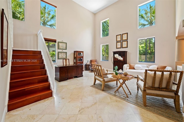 8205 SW 171st Ter, Palmetto Bay, FL 33157 - sitting room with a towering ceiling, light marble finish floors, and stairs