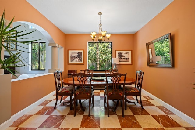 8205 SW 171st Ter, Palmetto Bay, FL 33157 - dining space with arched walkways and a chandelier