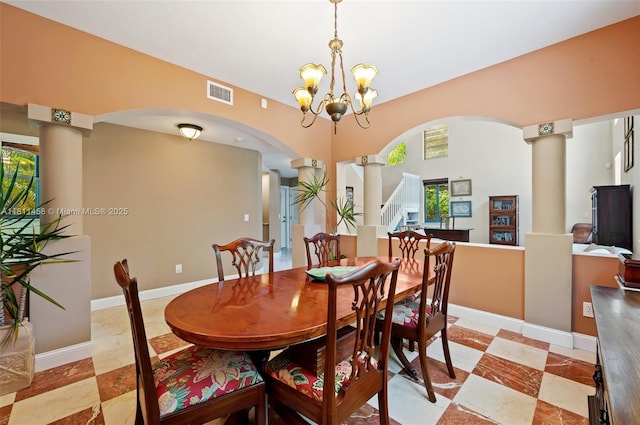 8205 SW 171st Ter, Palmetto Bay, FL 33157 - dining room with arched walkways, decorative columns, a chandelier, and stairs