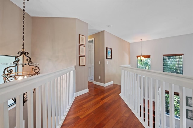 8205 SW 171st Ter, Palmetto Bay, FL 33157 - corridor featuring a chandelier, wood finished floors, and healthy amount of natural light