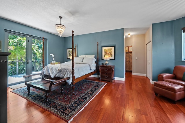 8205 SW 171st Ter, Palmetto Bay, FL 33157 - bedroom with access to exterior, wood finished floors, a chandelier, and french doors