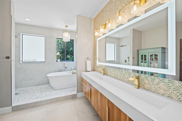 8205 SW 171st Ter, Palmetto Bay, FL 33157 - full bathroom with a walk in shower, vanity, a freestanding bath, tile patterned flooring, and a chandelier