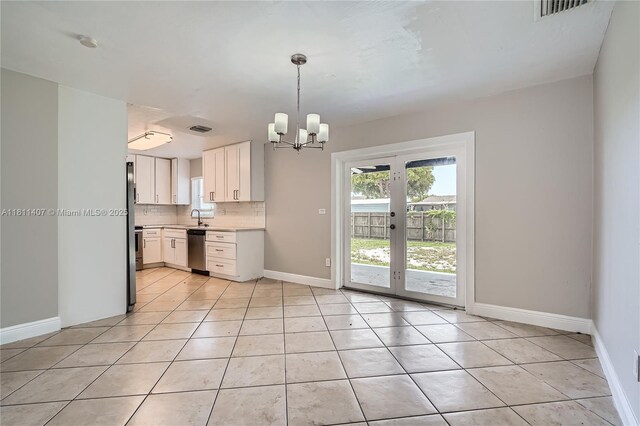 20701 Eagle Nest Rd, Cutler Bay, FL 33189 - kitchen with stainless steel dishwasher, a sink, light countertops, backsplash, and a chandelier
