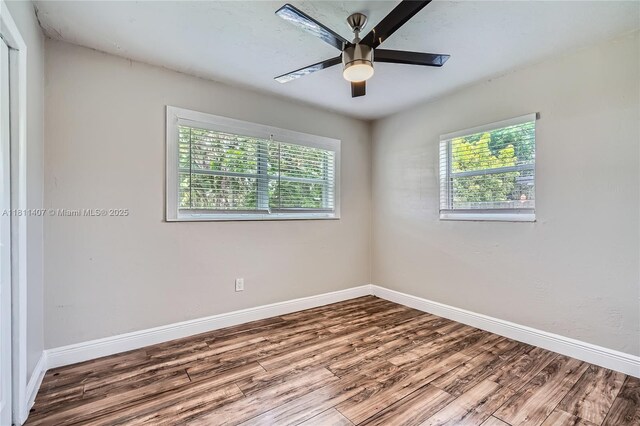 20701 Eagle Nest Rd, Cutler Bay, FL 33189 - spare room with healthy amount of natural light, wood finished floors, baseboards, and ceiling fan