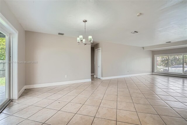 20701 Eagle Nest Rd, Cutler Bay, FL 33189 - unfurnished room with a chandelier, light tile patterned floors, and healthy amount of natural light