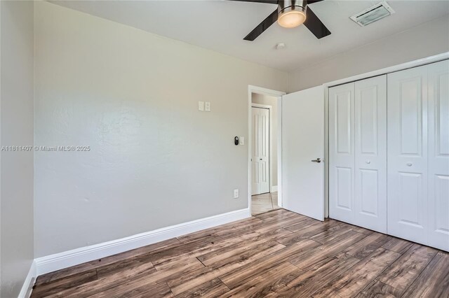 20701 Eagle Nest Rd, Cutler Bay, FL 33189 - unfurnished bedroom with wood finished floors, a closet, baseboards, and a ceiling fan