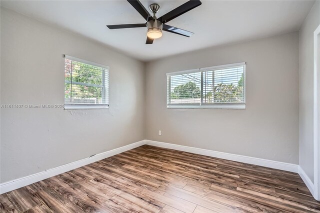 20701 Eagle Nest Rd, Cutler Bay, FL 33189 - empty room with plenty of natural light, wood finished floors, and baseboards