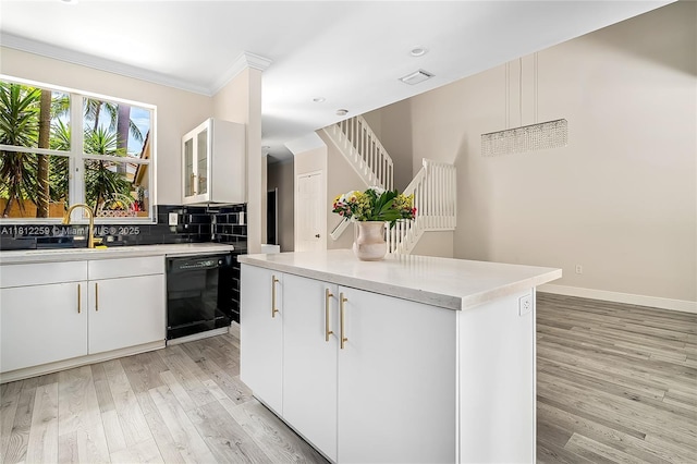 21024 NE 34th Ct, Aventura, FL 33180 - kitchen with dishwasher, a sink, light wood-style flooring, light countertops, and white cabinets