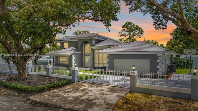 7201 SW 84th Pl, Miami, FL 33143 - view of front facade featuring a fenced front yard, central AC unit, a garage, concrete driveway, and stucco siding
