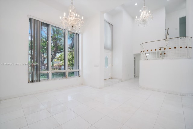 7201 SW 84th Pl, Miami, FL 33143 - unfurnished living room with a chandelier, tile patterned flooring, and a high ceiling