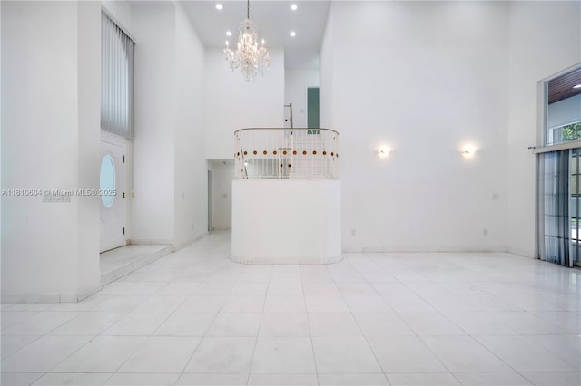 7201 SW 84th Pl, Miami, FL 33143 - unfurnished living room with a high ceiling, a chandelier, tile patterned flooring, and recessed lighting
