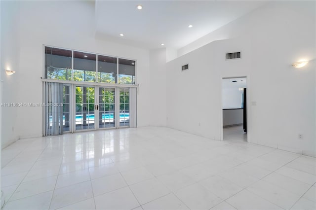 7201 SW 84th Pl, Miami, FL 33143 - spare room with a towering ceiling, light tile patterned floors, and recessed lighting