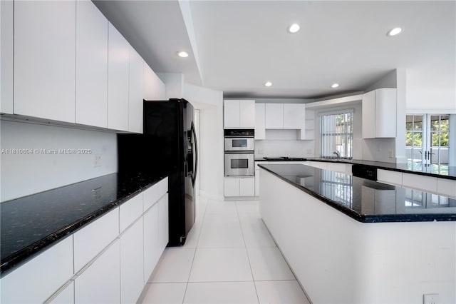 7201 SW 84th Pl, Miami, FL 33143 - kitchen with black appliances, dark stone countertops, light tile patterned floors, white cabinetry, and recessed lighting
