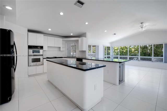 7201 SW 84th Pl, Miami, FL 33143 - kitchen featuring black appliances, a peninsula, a center island, recessed lighting, and white cabinetry