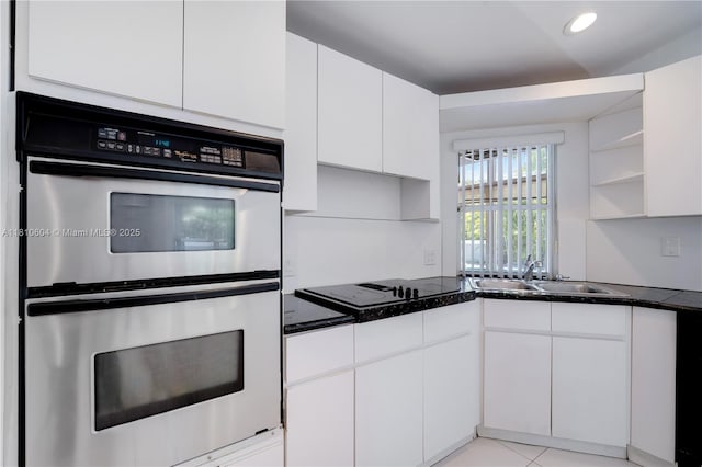 7201 SW 84th Pl, Miami, FL 33143 - kitchen with stainless steel double oven, open shelves, a sink, black electric cooktop, and white cabinets