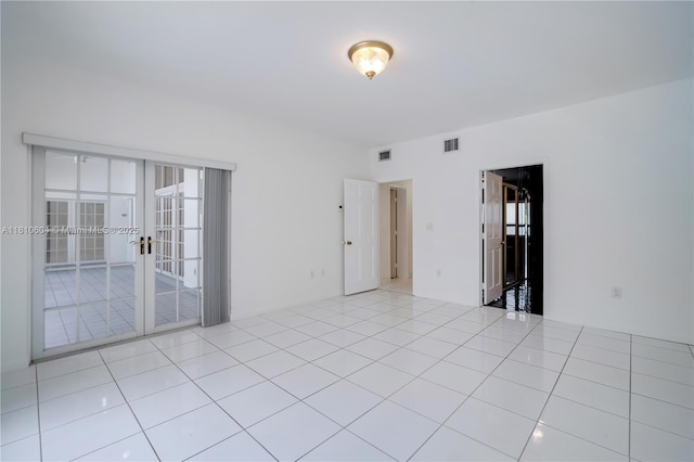 7201 SW 84th Pl, Miami, FL 33143 - empty room with french doors and light tile patterned flooring