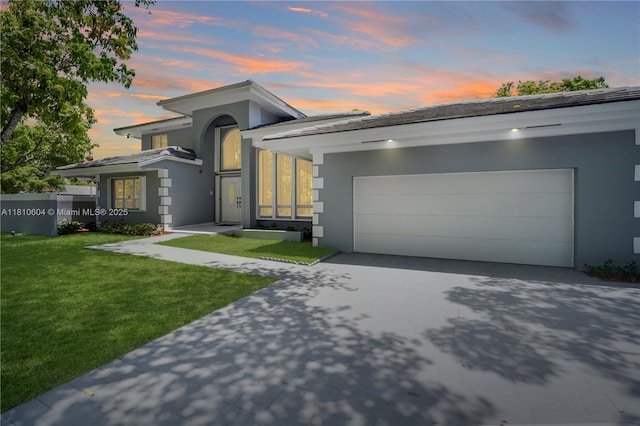 7201 SW 84th Pl, Miami, FL 33143 - view of front facade with stucco siding, driveway, a front lawn, and an attached garage