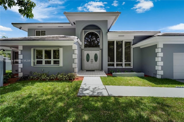 7201 SW 84th Pl, Miami, FL 33143 - doorway to property with stucco siding and a yard