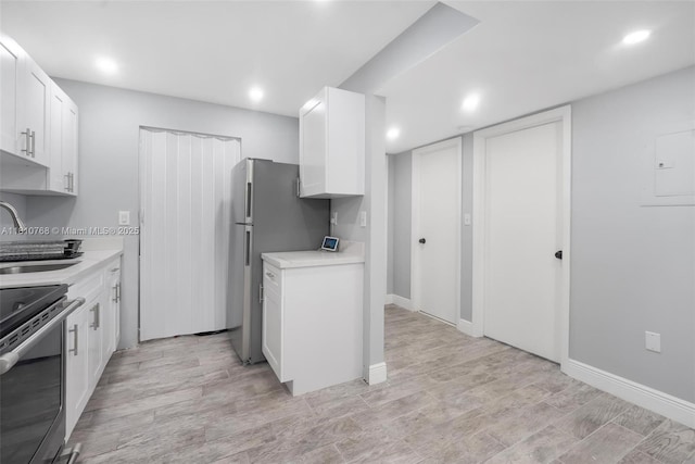 469 NE 207th Ln Unit 205, Miami, FL 33179 - kitchen featuring appliances with stainless steel finishes, light countertops, a sink, white cabinetry, and recessed lighting