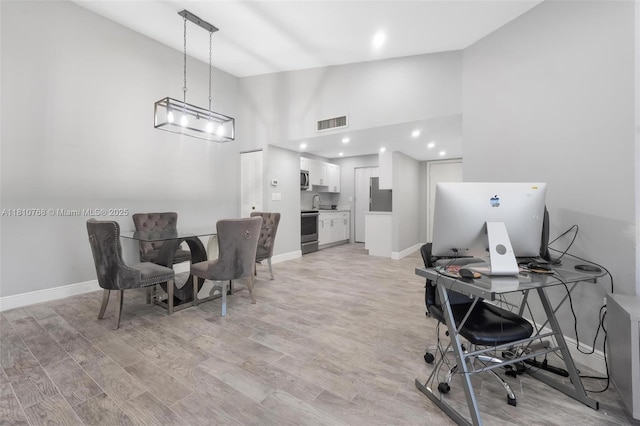 469 NE 207th Ln Unit 205, Miami, FL 33179 - office space featuring high vaulted ceiling, light wood-type flooring, baseboards, and recessed lighting
