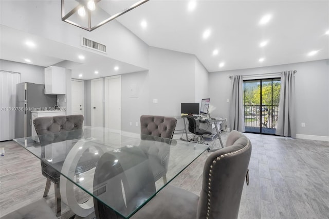 469 NE 207th Ln Unit 205, Miami, FL 33179 - dining space with light wood-style floors, baseboards, a desk, recessed lighting, and high vaulted ceiling