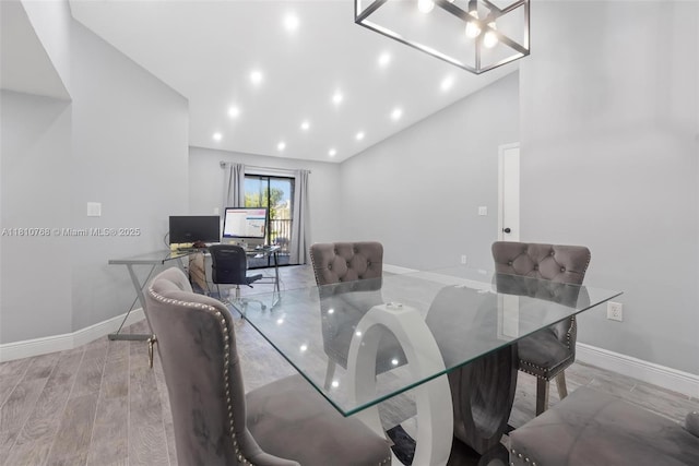 469 NE 207th Ln Unit 205, Miami, FL 33179 - dining room featuring baseboards, vaulted ceiling, a chandelier, and wood finished floors